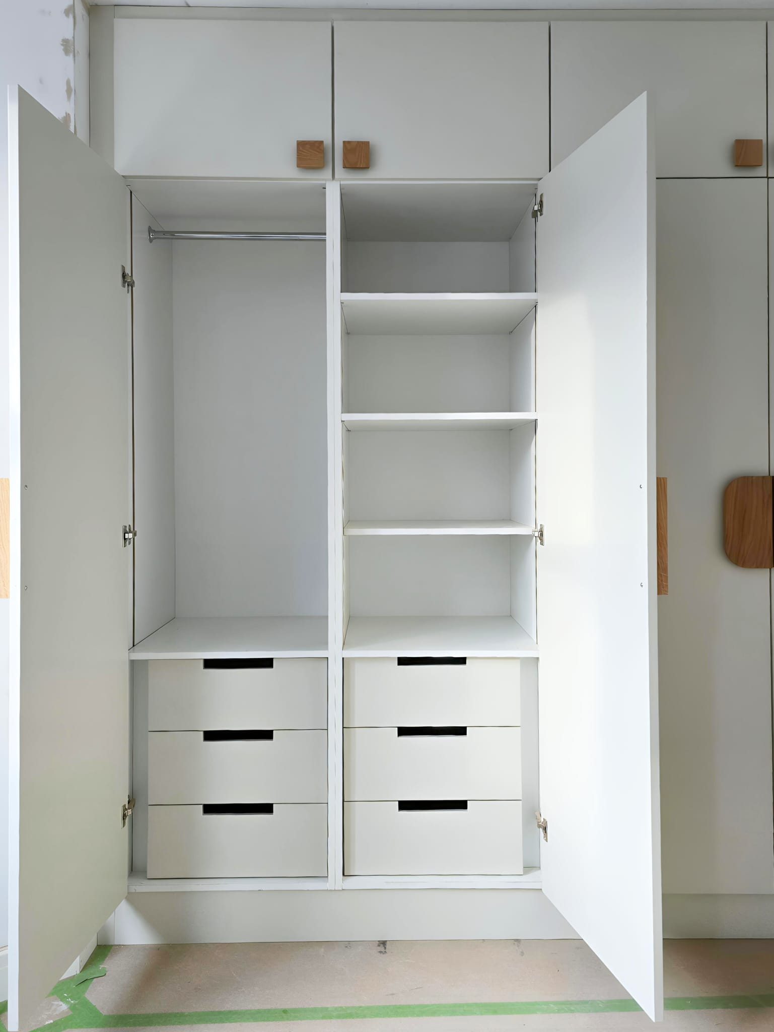 Internal drawers, shelves and hanging space inside a fitted wardrobe in Hackney