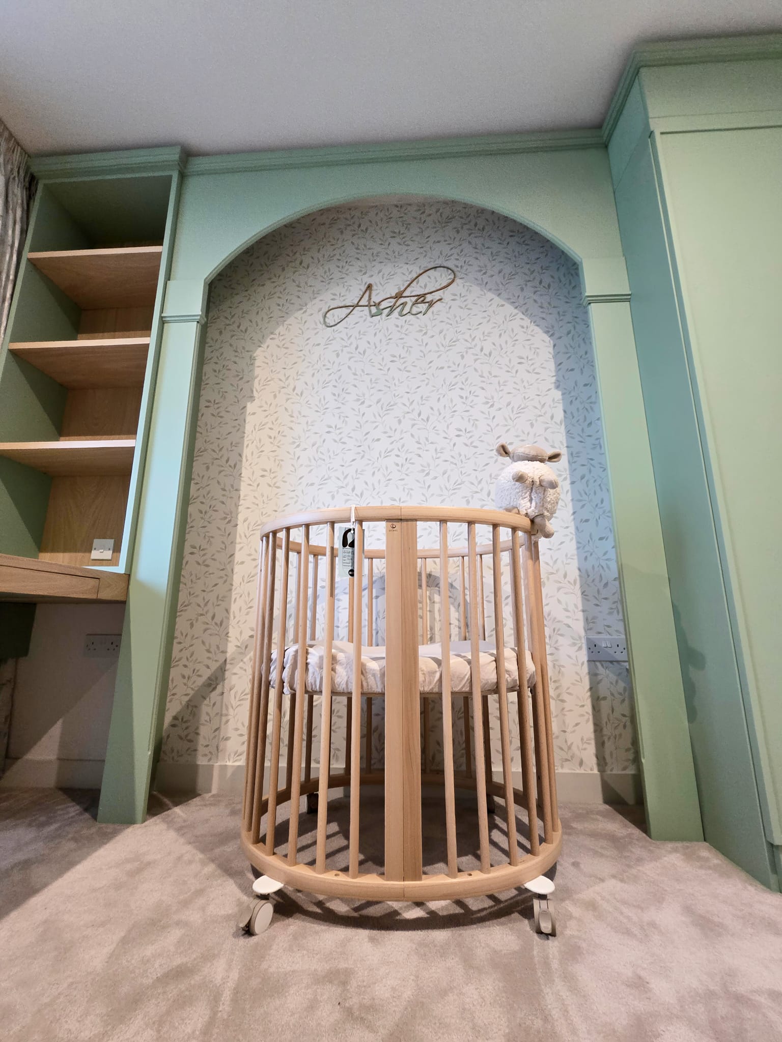 Arched cot area framed by bespoke fitted bedroom joinery in Greenwich