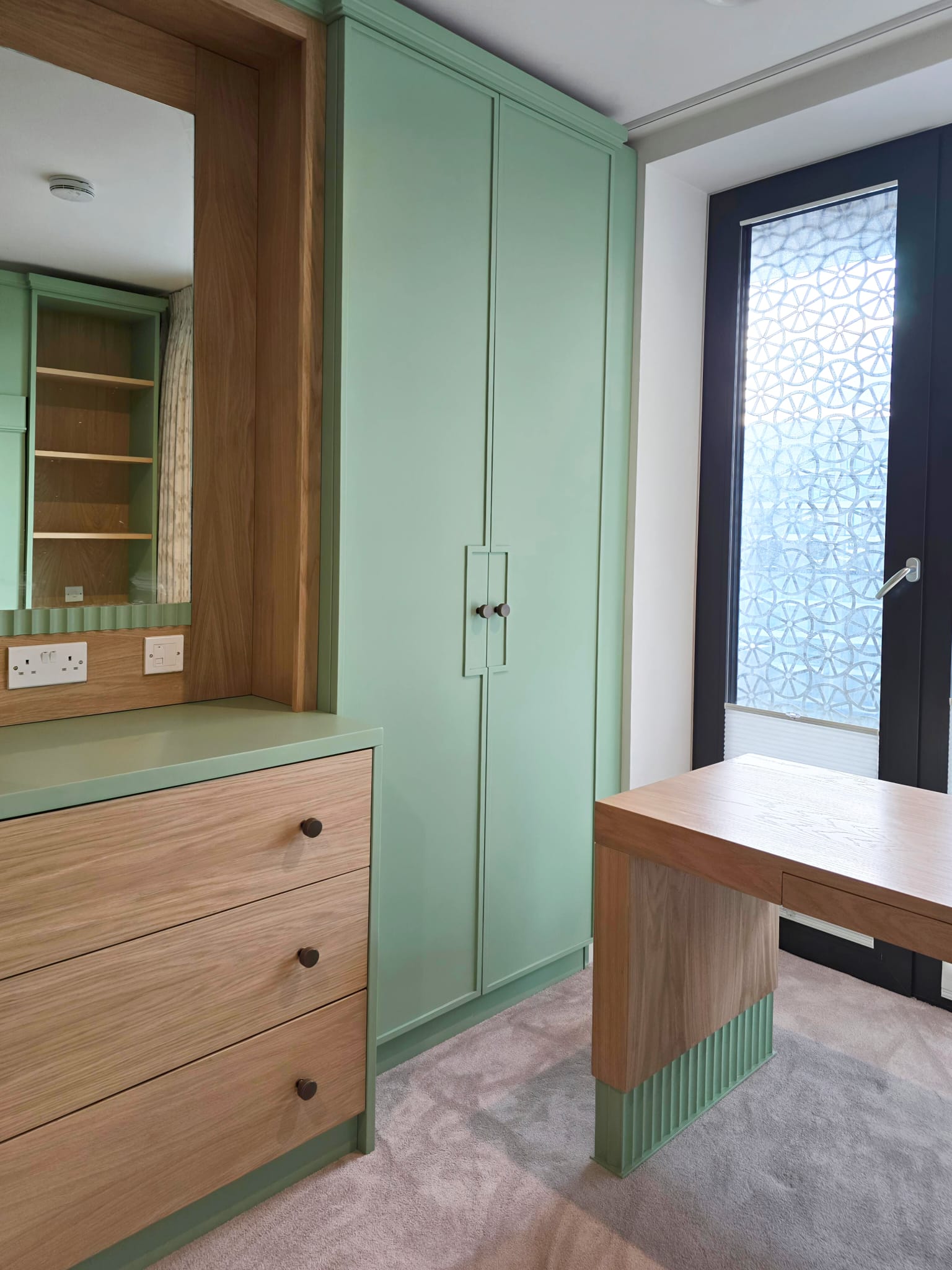 Fitted kids bedroom with natural oak desk, drawers and wardrobe storage in Greenwich