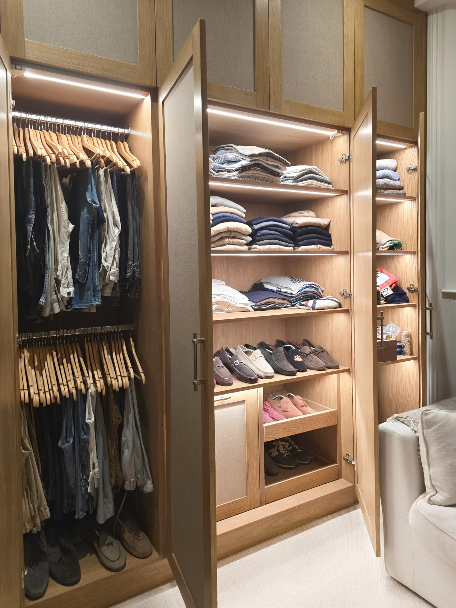 Open fitted wardrobe interiors with hanging, shelves and shoe storage at Saint Ann's Villas