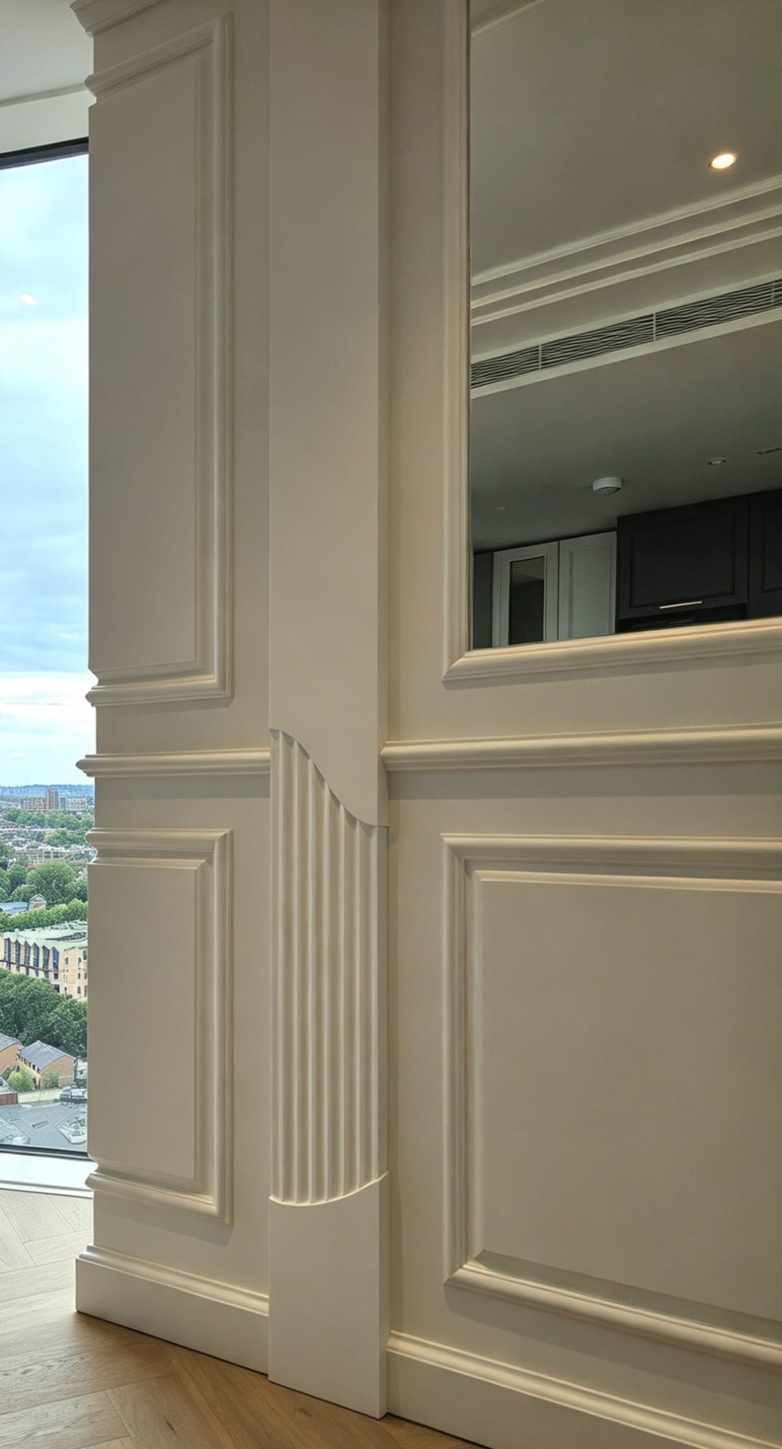 Chelsea wall panelling with a mirrored panel, fluted corner detail and painted mouldings