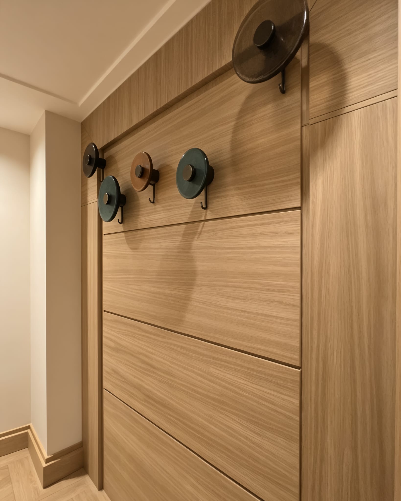 Bespoke oak hallway hanging wall with decorative hooks on John Islip Street in London