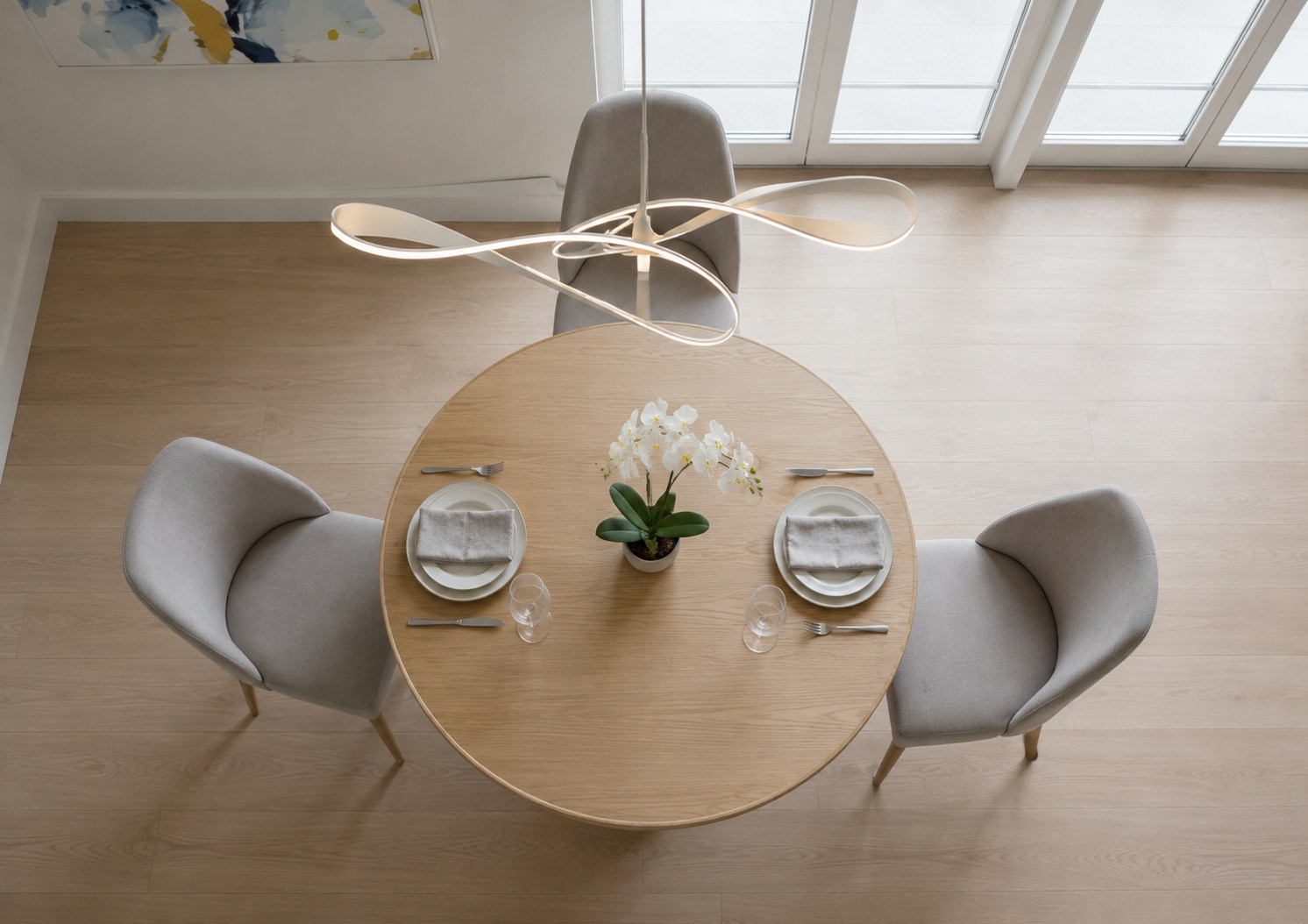 Overhead view of a bespoke round oak dining table set for four in Richmond