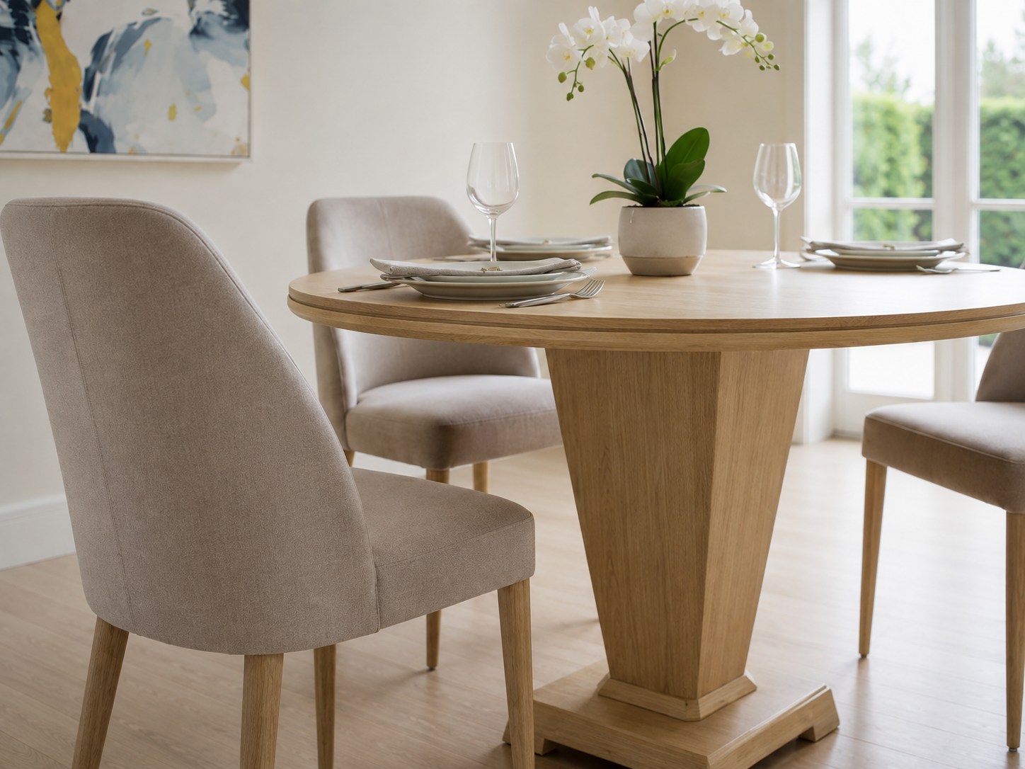 Contemporary round oak pedestal dining table in a bright Richmond dining room