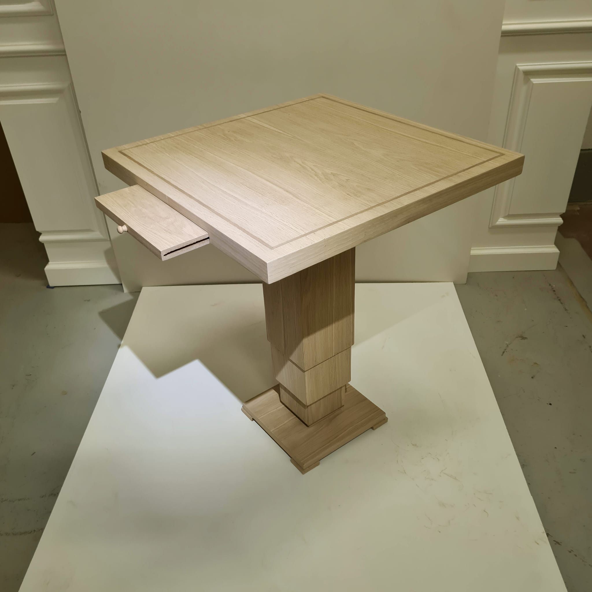 Completed oak square pedestal writing table with concealed drawer