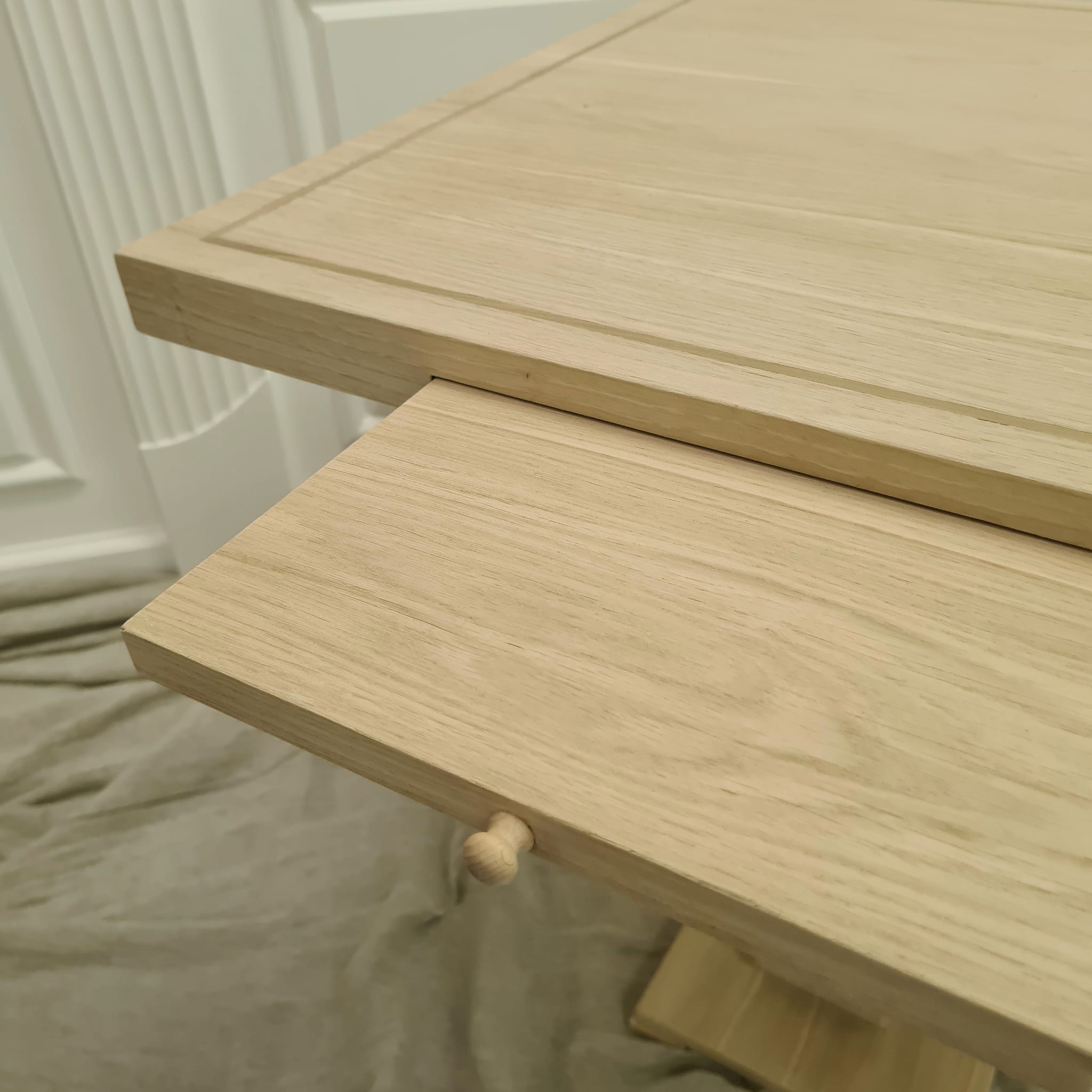 Close production view of the concealed writing drawer and timber grain