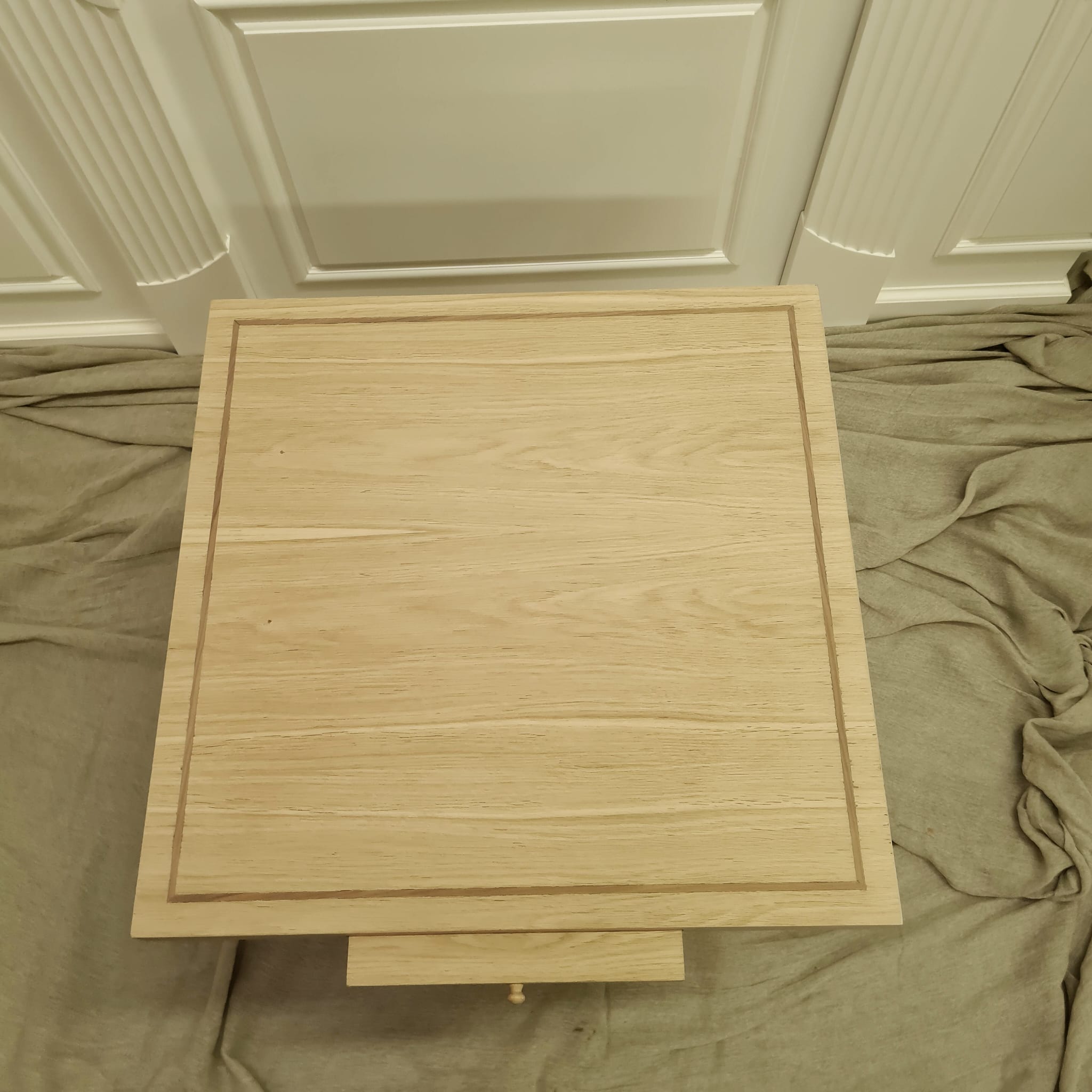 Overhead production view of the oak writing surface and contrasting inset line