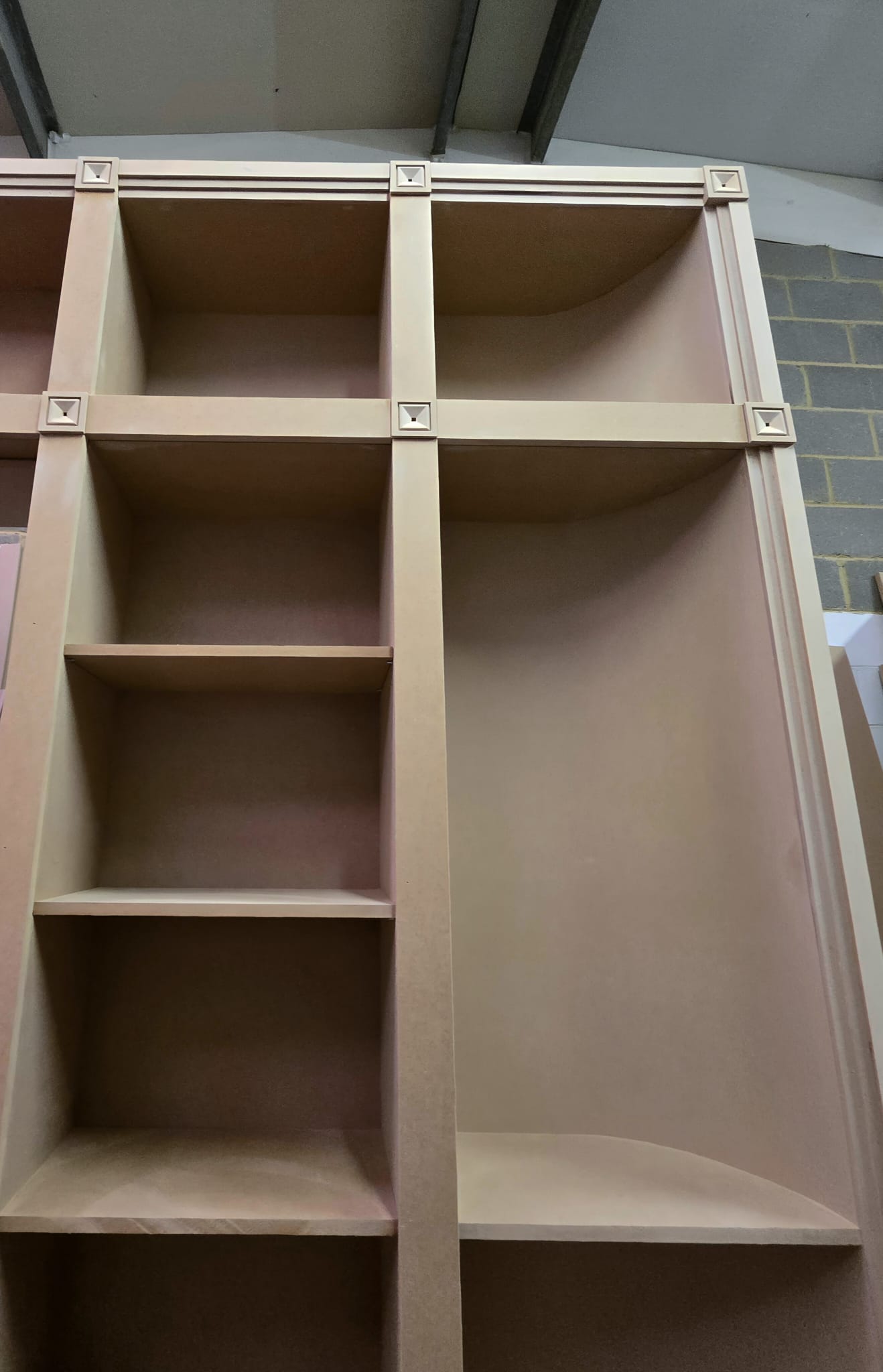 Bookcase in the workshop showing shelf construction and square decorative trim blocks