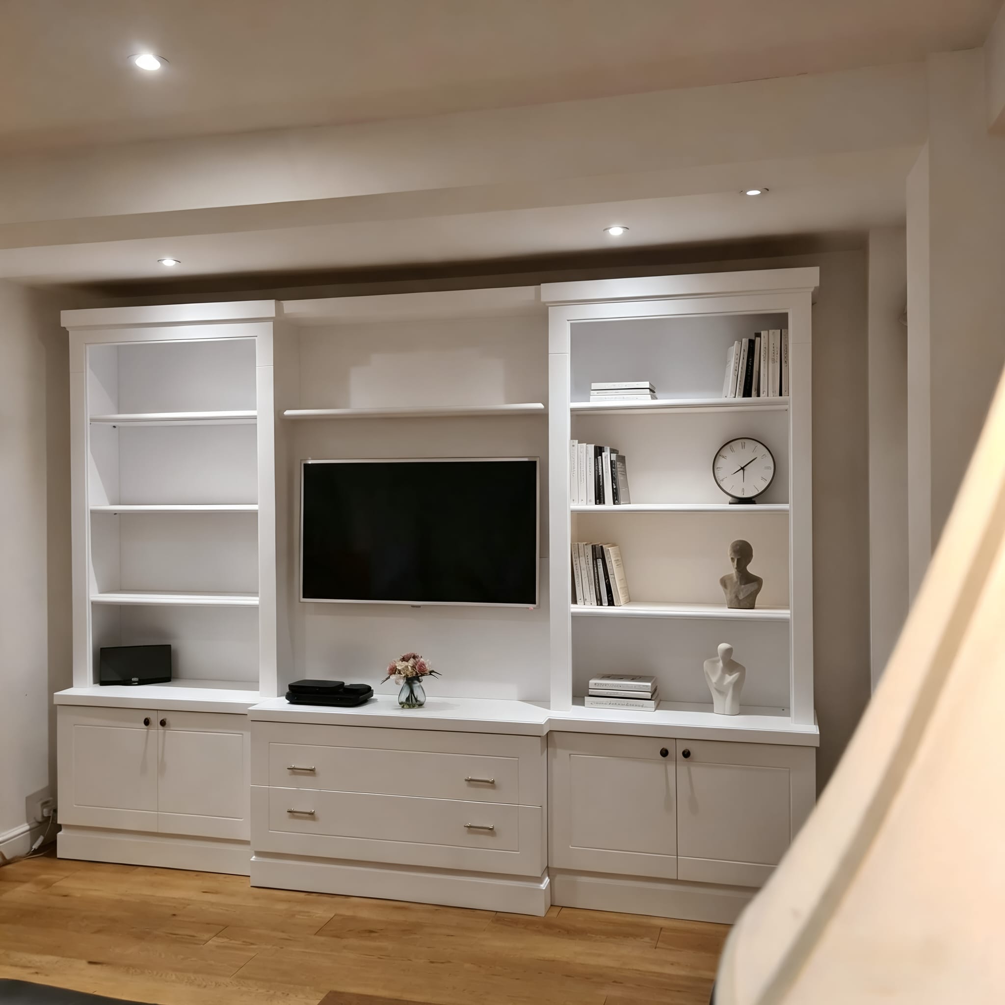 Wide view of a bespoke living-room TV unit in Lancaster Gate