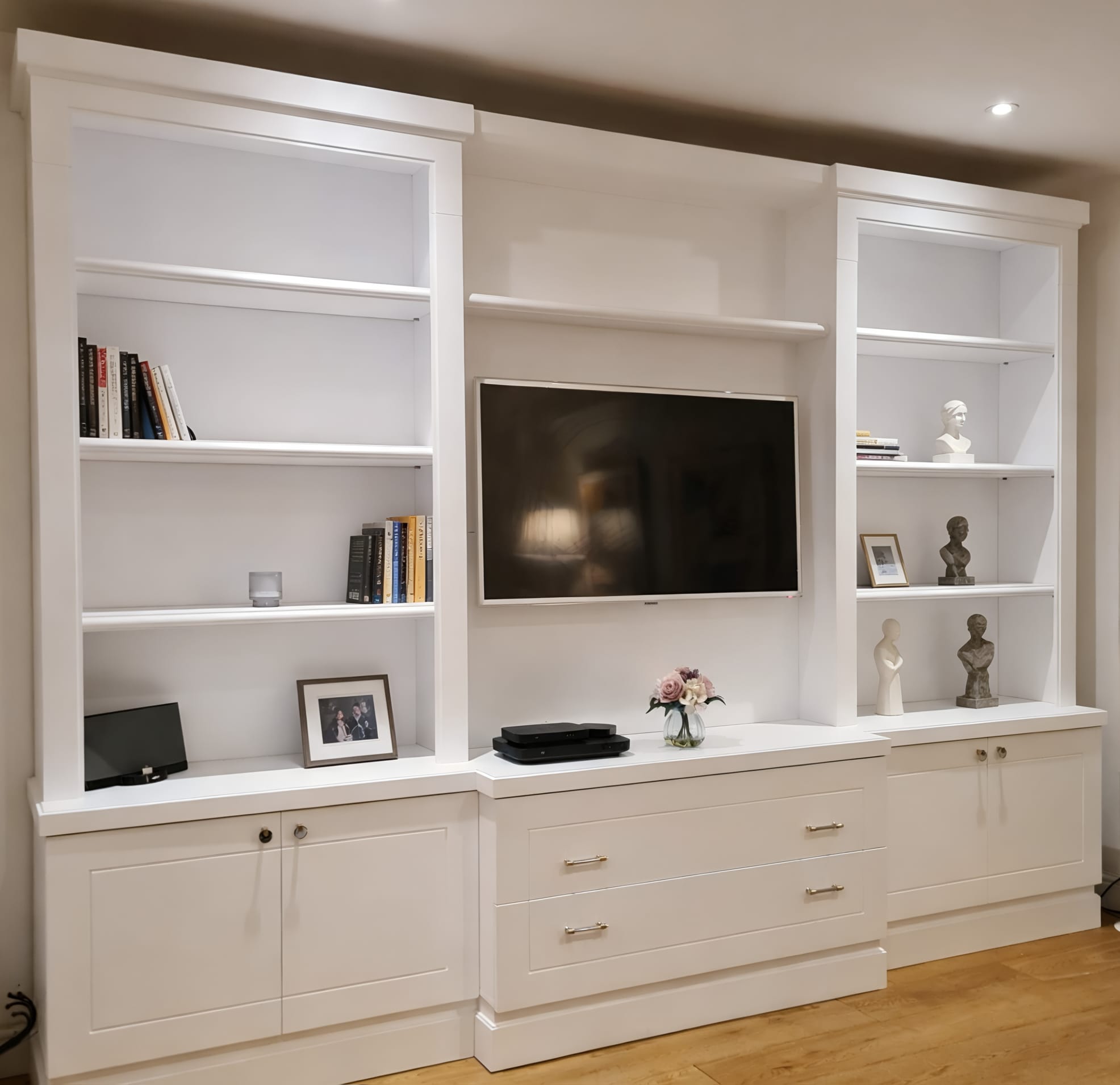 Classical built-in media wall with TV, shelves and cupboards in Lancaster Gate