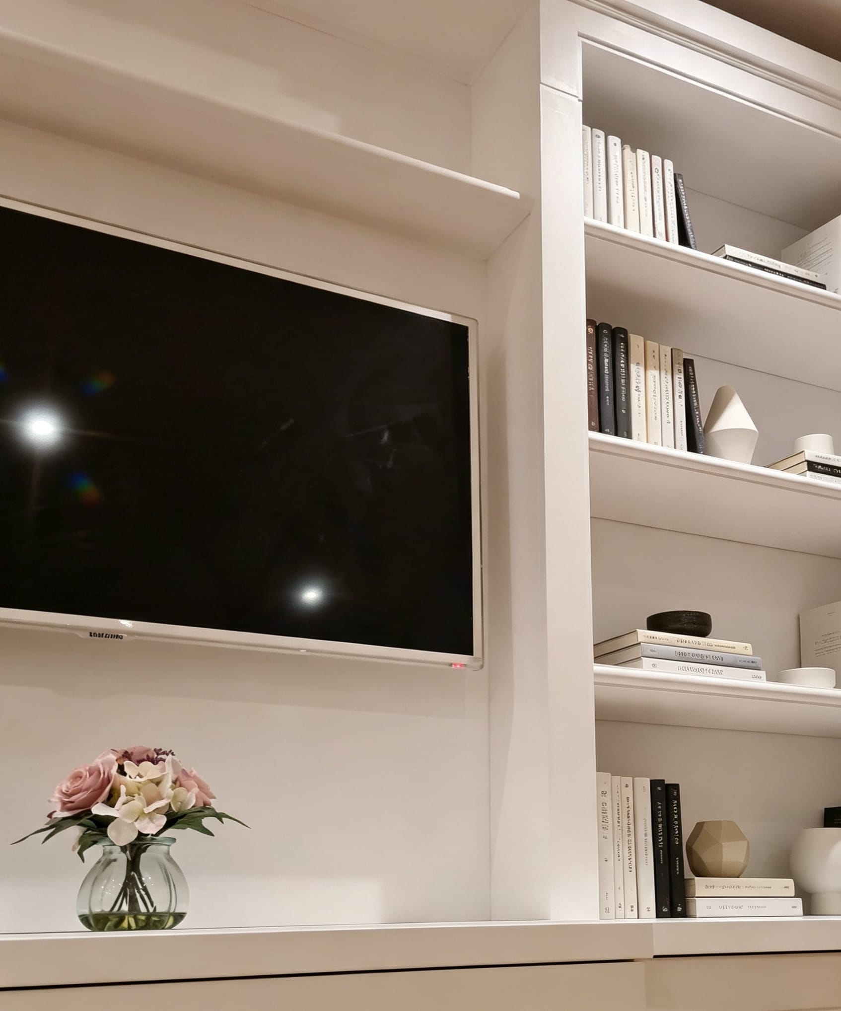 Painted TV wall with symmetrical display shelving in Bayswater, London