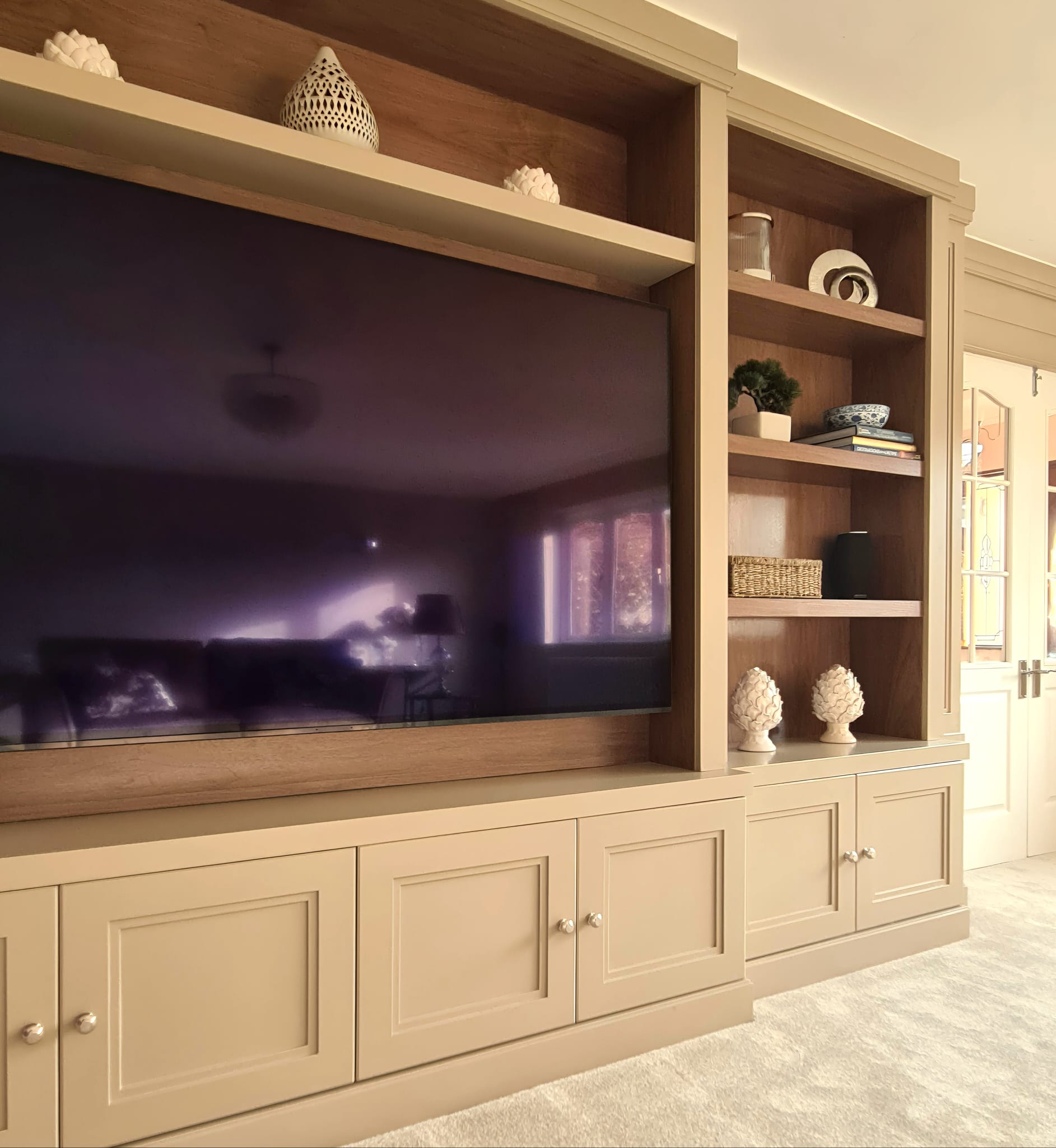 Bespoke TV unit with panelled base storage in Brentwood