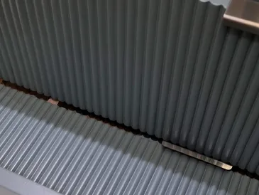 Even grey spray-painted finish across fluted furniture surfaces