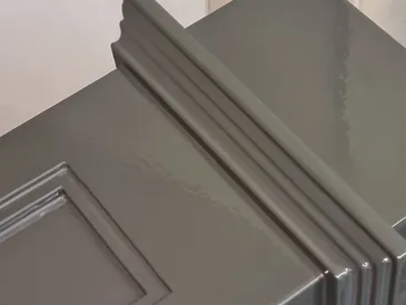 Grey gloss spray-painted panelled cabinet door detail
