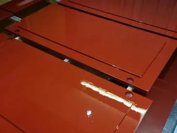 High-gloss red spray-painted cabinet doors in the workshop
