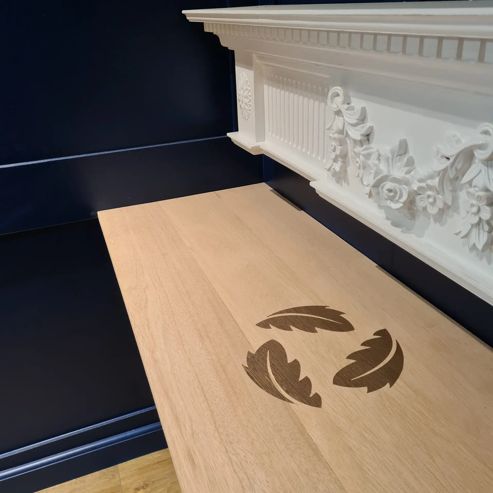 Bespoke feather inlay detail on oak panel