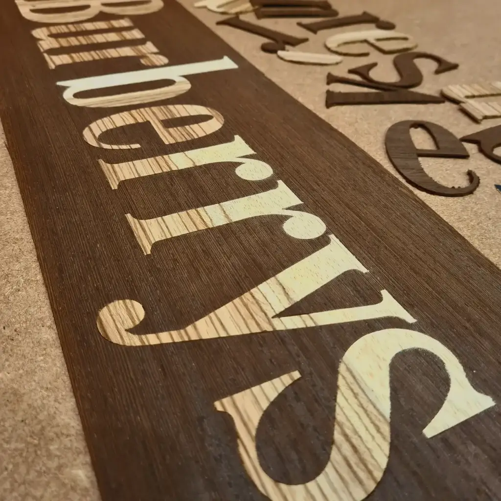 Precision-engraved veneered MDF signage