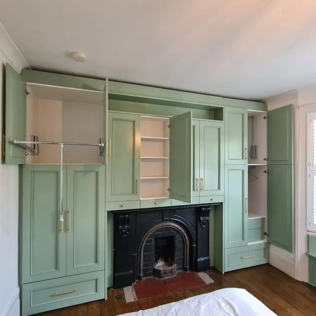 Completed full-wall sage fitted wardrobes in a period Bromley home
