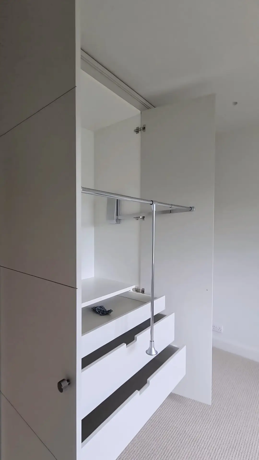 Tailored wardrobe interior built flush to the ceiling in Wimbledon, London