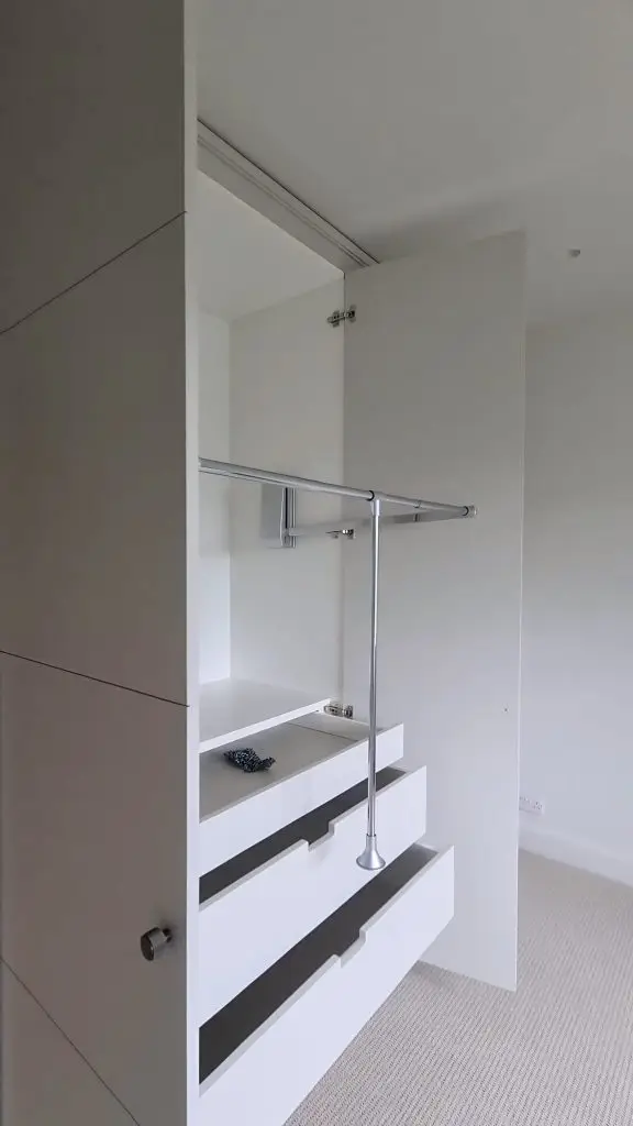 Tailored wardrobe interior built flush to the ceiling in Wimbledon, London