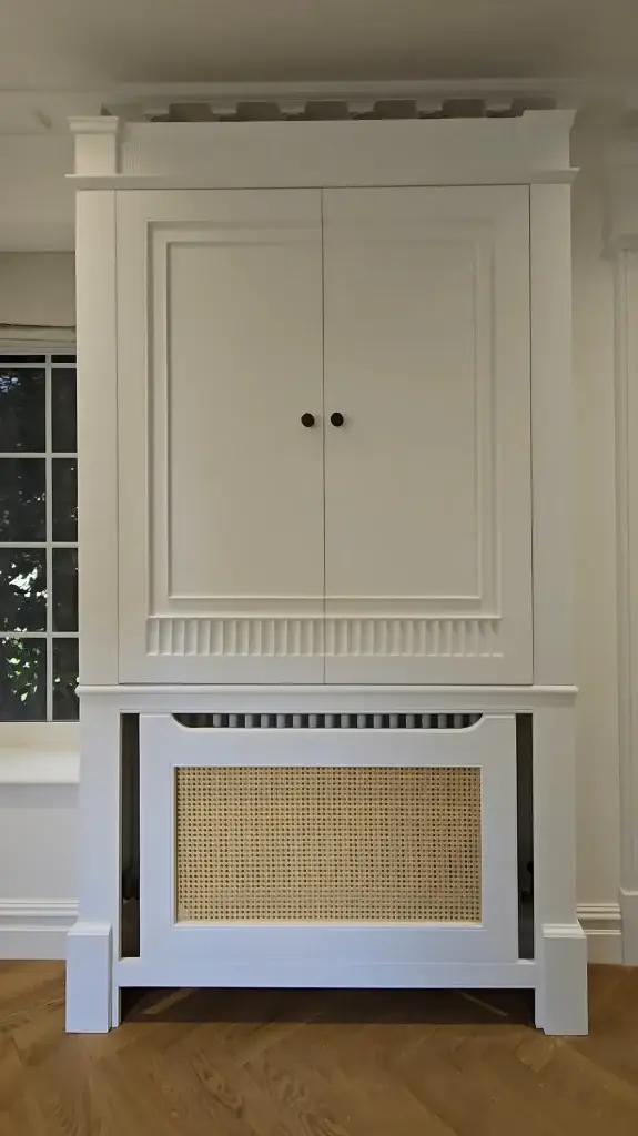 Fitted hallway cabinet with shaker-style panels and brass hardware in Camberley