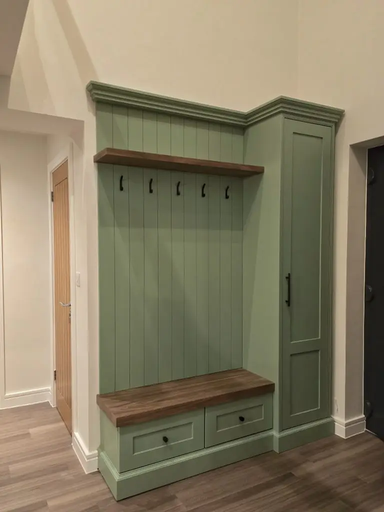 Fitted hallway unit with open shoe shelving and coat hooks in Stansted Mountfitchet