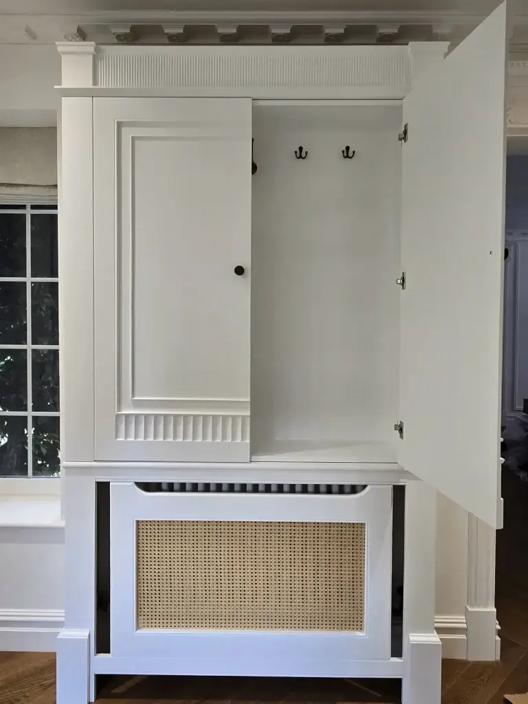 Fluted hallway cabinet detail with an integrated cane radiator grille in Camberley