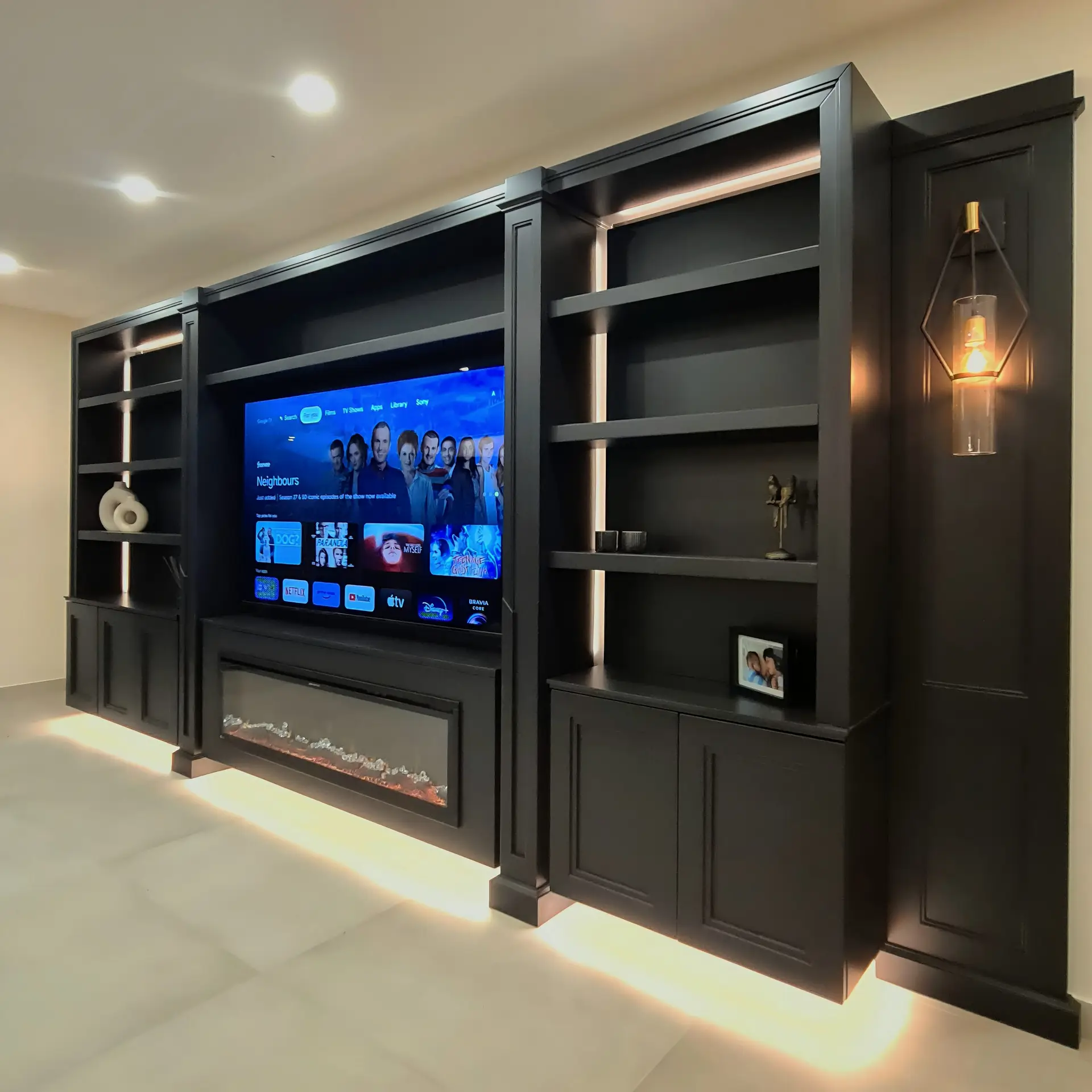 Solidly constructed anthracite media wall with integrated fireplace in Rickmansworth