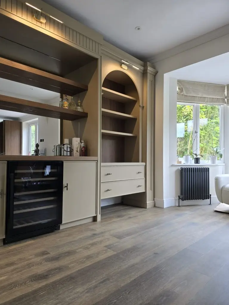 Arched display niche with walnut shelving and integrated wine storage