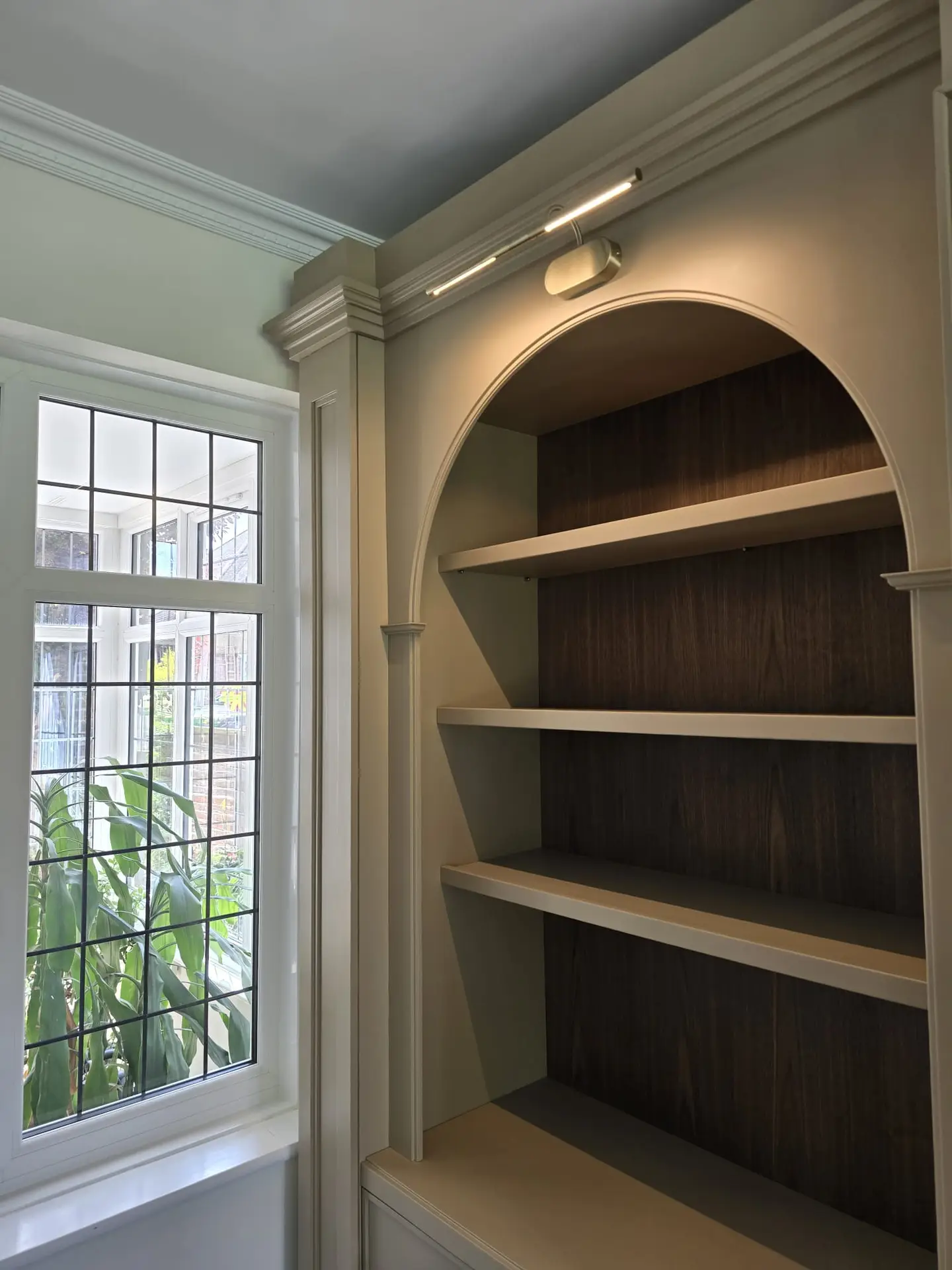 Fluted cabinetry and picture lighting on the Harrow display joinery