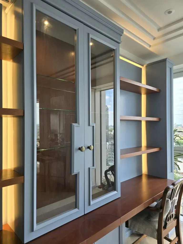 Glazed display cabinets, mahogany shelves and integrated workspace in Chelsea Creek