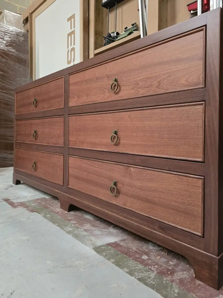 Detail of sapele veneer and brass ring pull handles on vanity unit, Kent