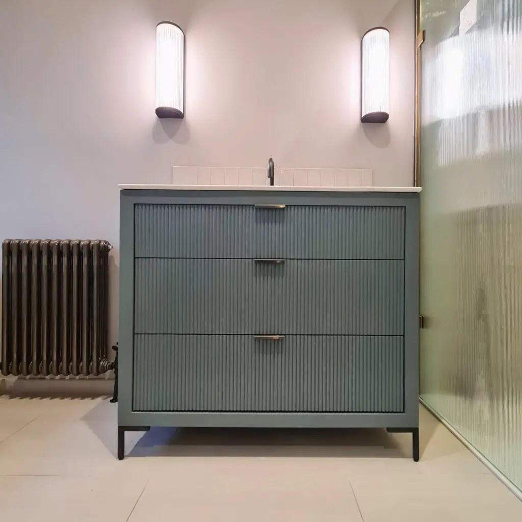 Fluted sage vanity unit with U-shaped middle drawer around basin plumbing, Wimbledon, London