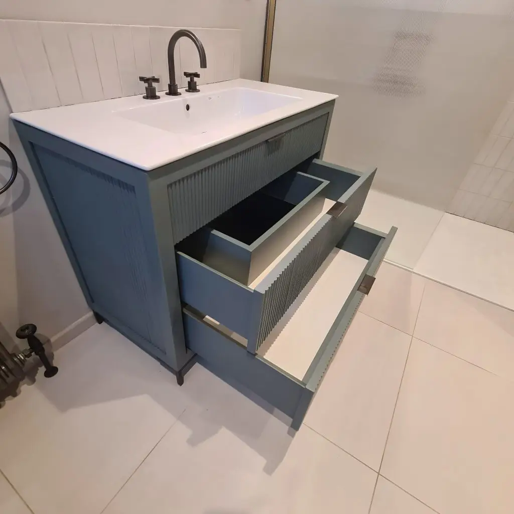 Open drawers showing the tailored internal construction of a fluted sage vanity unit