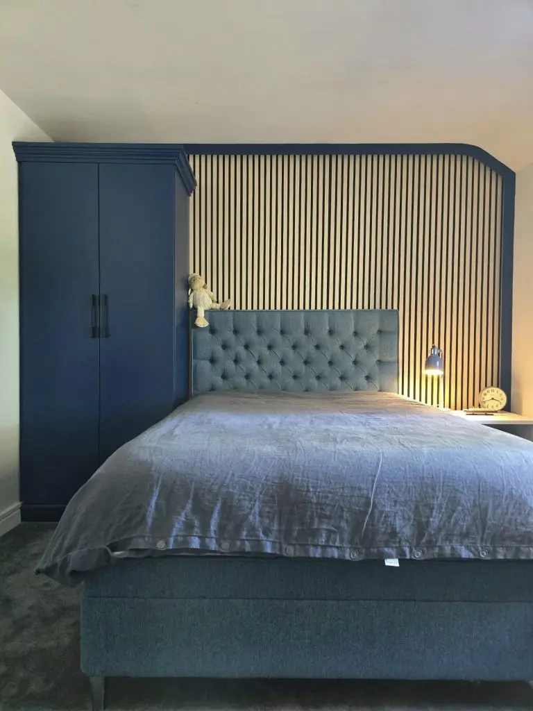 Navy fitted wardrobe with slatted headboard wall in attic bedroom, Stansted Mountfitchet, Essex
