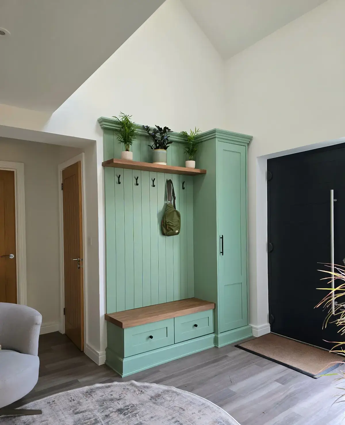 Sage-green fitted hallway bench and shoe storage in Stansted Mountfitchet, Essex